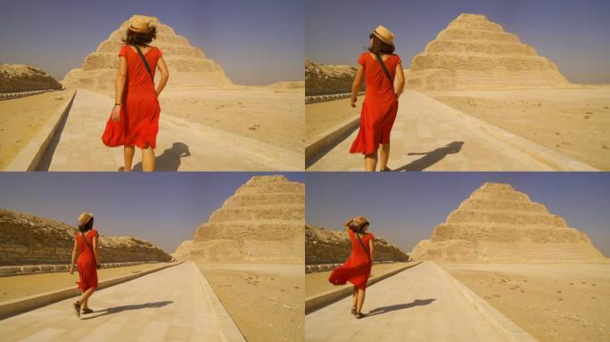 萨卡拉 (Saqqara) Djoser阶梯金字塔上穿着红色连衣裙的年轻游客。埃及。孟菲斯最重要的墓