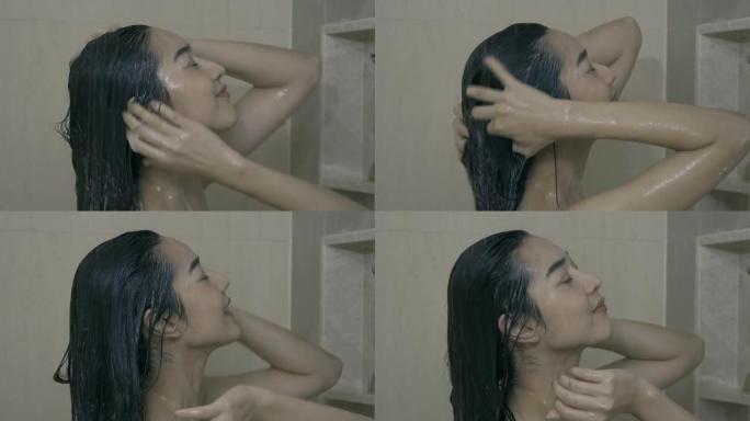 美丽的女人洗热水澡，冲洗掉头发的洗发水。
