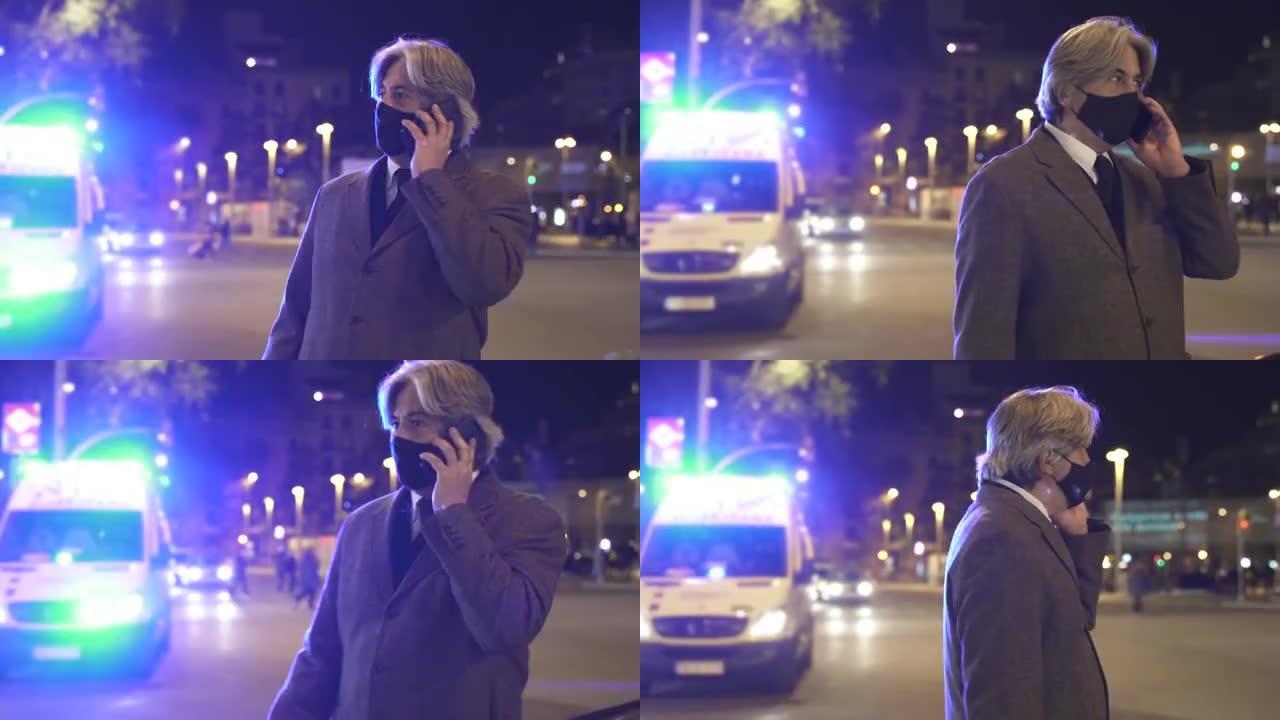 晚上在城市的救护车灯前打电话给戴着口罩的人。呼救。冠状病毒大流行期间的事故紧迫性