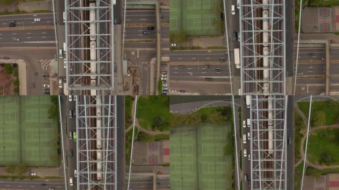 在威廉斯堡大桥上行驶的地铁列车并穿越纽约市繁忙的多车道高速公路之后，自上而下的空中鸟瞰图
