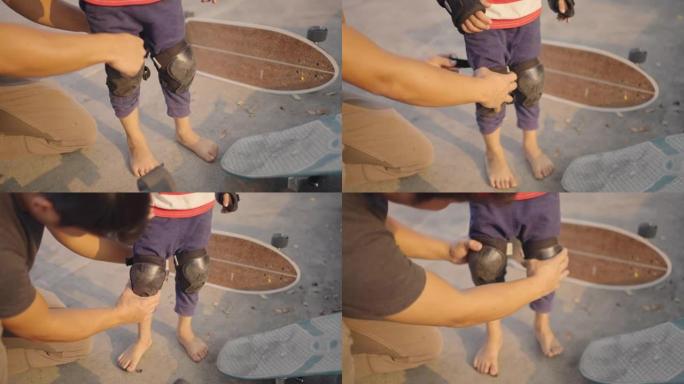 男子帮助孩子在滑板前戴防护护膝。