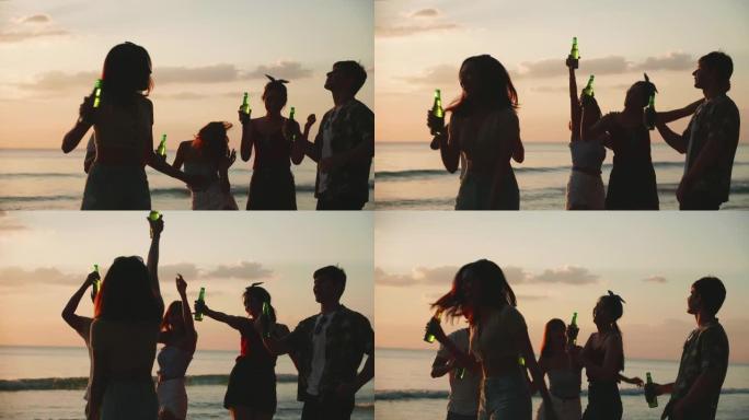 一群年轻的亚洲人在海滩上享受派对。一群朋友在暑假玩得开心喝啤酒。