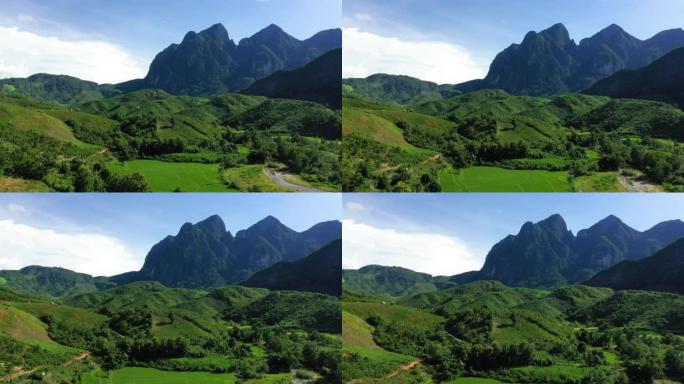 大自然中的老挝景观，其森林和绿色的山脉位于农基，在季风下，在阳光明媚的日子里，由无人机驶向亚洲老挝琅