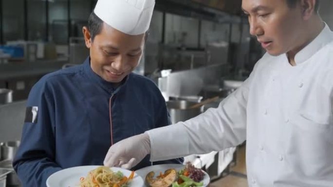 厨师团队在酒店餐厅的厨房里准备食物。饮食概念。