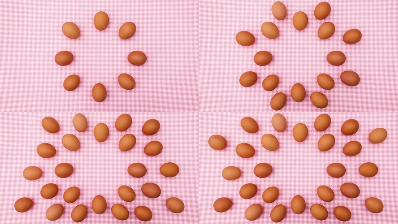 新鲜鸡蛋创意出现在粉红色主题上。停止运动