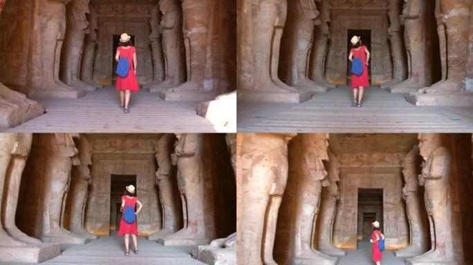 一名年轻女子正在参观阿布辛贝神庙的内室，位于埃及南部努比亚，靠近纳赛尔湖。拉姆斯二世法老庙，4k视频