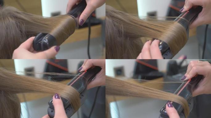 美发师在美女的金发上做发型特写