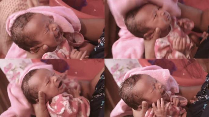 新生婴儿洗澡。美丽的新生男婴特写镜头 (6天大) 躺在产前医院的妈妈腿上。裹着婴儿毯的孩子 (保暖的