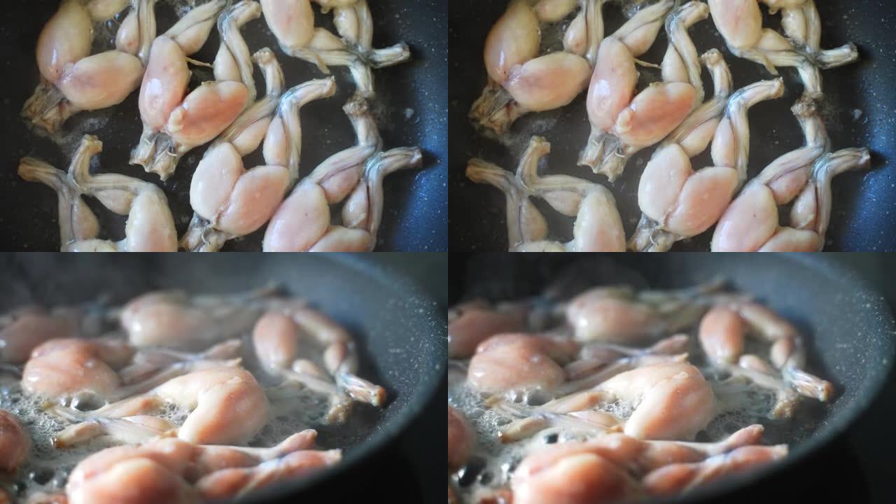 平底锅上油炸蛙腿的传统烹饪。