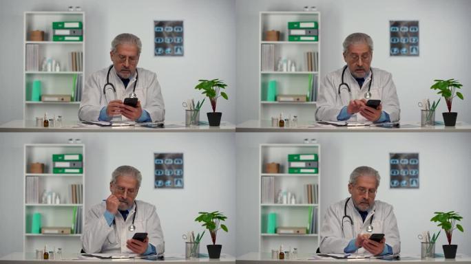 男医生填写病史，并建议患者使用手机治疗疾病，发送短信。穿着白色医用外套的医生坐在医院办公室的桌子旁。