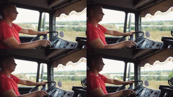 卡车司机在晴天操作卡车穿过乡村。男子把手放在方向盘上，控制着一辆汽车行驶到目的地。卡车司机在乡间道行