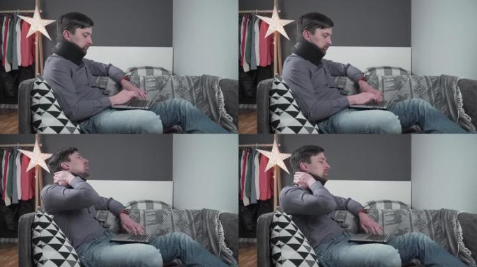 男子员工在事故发生后在家中笔记本电脑后面工作，感到颈部疼痛，使用黑色颈圈支撑。男性颈部受伤自由职业程