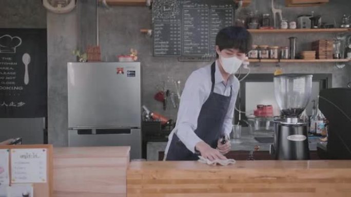 亚洲男子清洁柜台擦桌子特写咖啡店服务员视