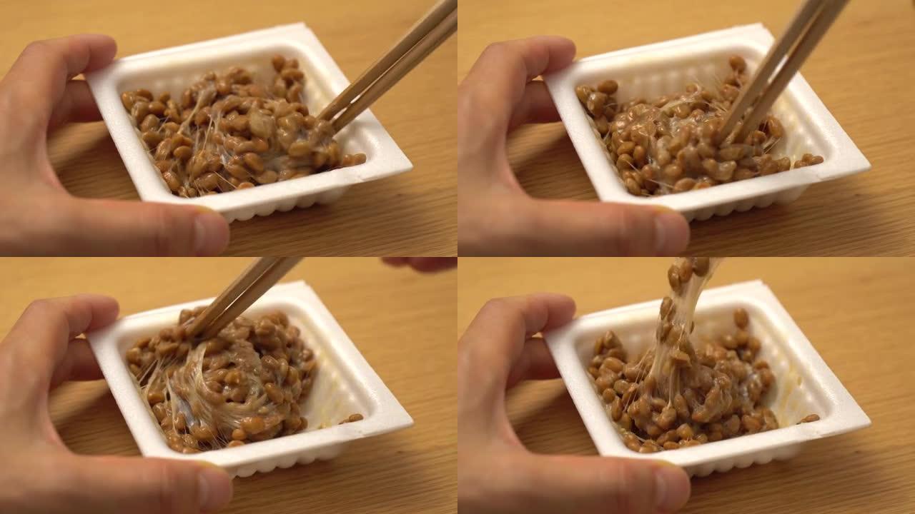 用筷子慢慢搅拌纳豆 (日本料理)
