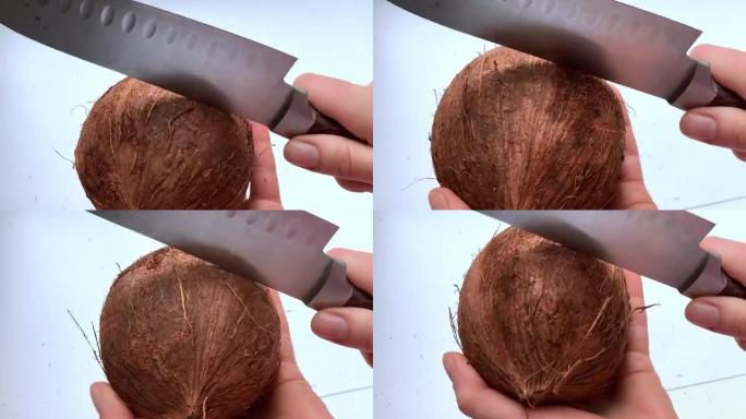 女人用刀劈开椰子壳
