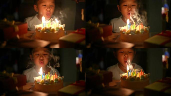 亚洲孩子带着他的生日蛋糕。庆祝和欢乐的概念