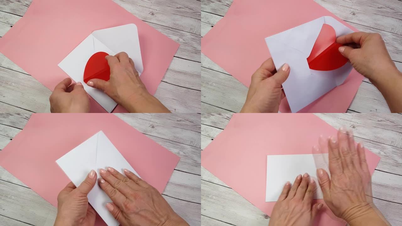 女人双手将一张红色心形的情人卡放在白色的信封中，向情人节快乐或特别的生日庆祝活动表白