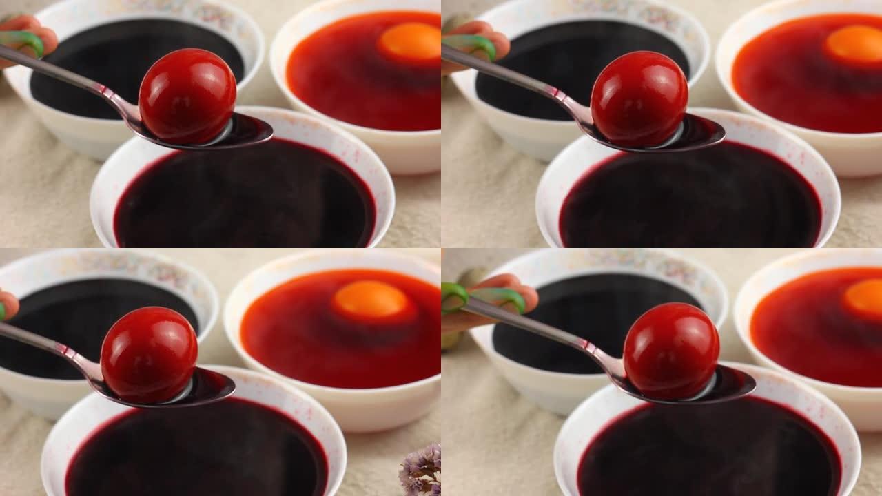 高加索儿童用金属勺子画一个复活节彩蛋，然后将其浸入带有红色染料的白色碗中。复活节假期的概念。