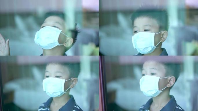 亚洲孩子在家戴口罩微笑。检疫的概念