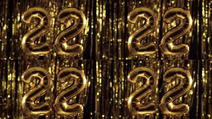 金色数字22 22由充气气球制成，在黄色背景上。一组完整的数字。生日、周年纪念日、日期的概念