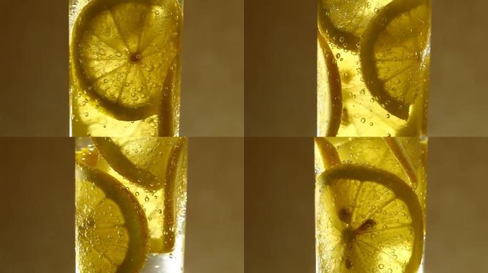 柠檬片在苏打水与气泡，苏打水，柠檬水在玻璃，逆时针旋转，转动。