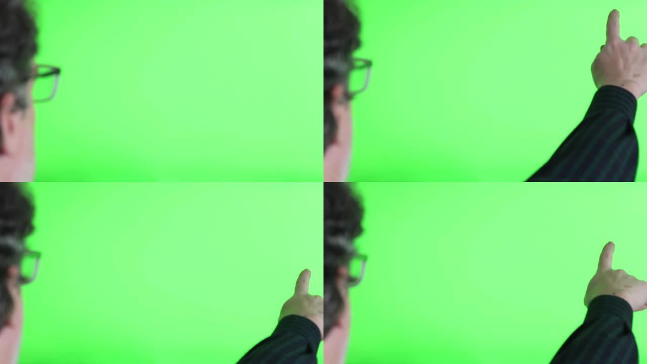 一个大的绿色触摸屏的特写镜头，一名男子在屏幕前互动