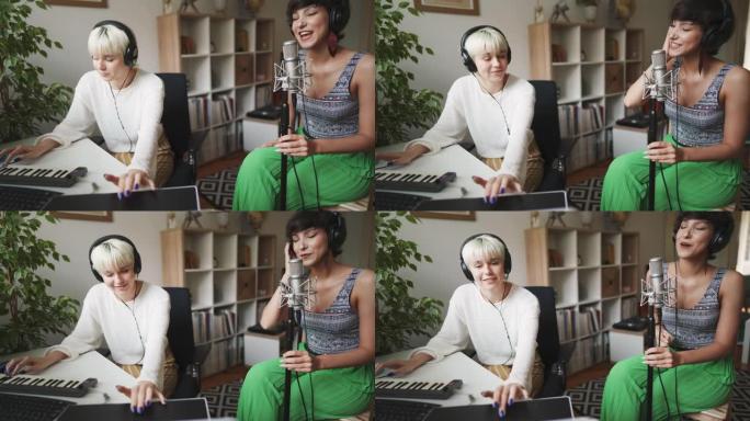欢快的女歌手在家庭工作室与制作人录制她的新歌