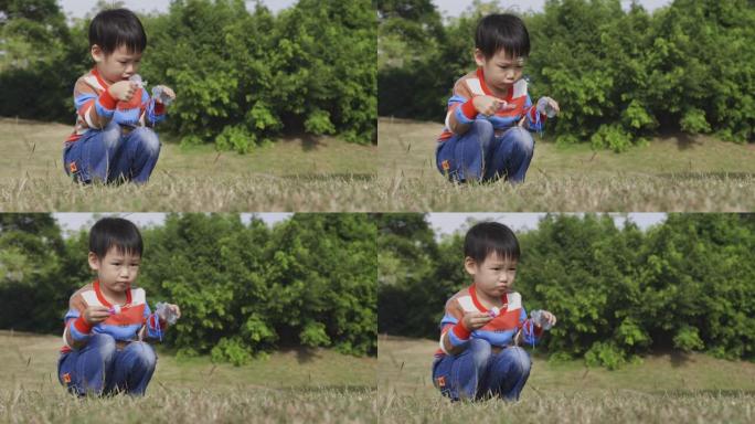 亚洲小男孩在户外玩得开心，吹泡泡