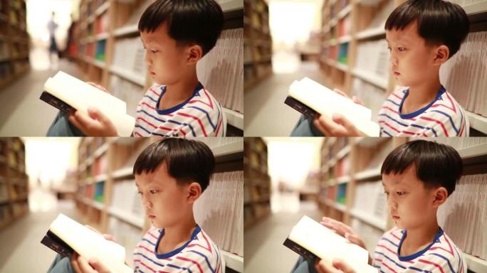 快乐的亚洲孩子在图书馆读书。