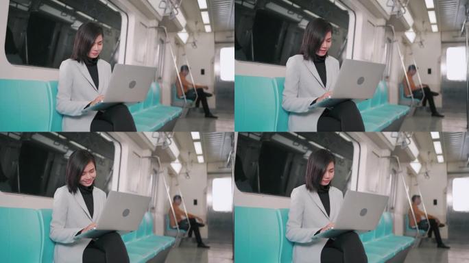 女商人在空中火车或地铁上使用笔记本电脑工作，他们的工作方式运输人们的生活方式和无线连接概念。