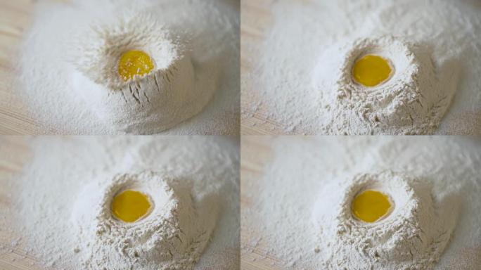 鸡蛋落入面粉中。慢动作拍摄