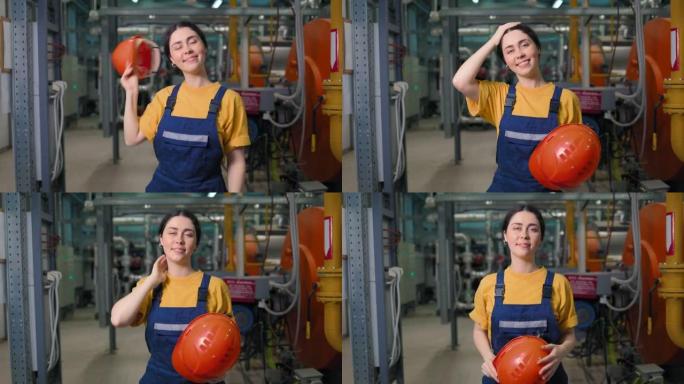 现代工业和制造业。一位年轻的高加索女工程师的肖像，她脱下防护头盔并微笑。相机向脸部移动