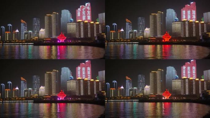 夜间著名的青岛市市中心照明秀步行湾全景4k中国