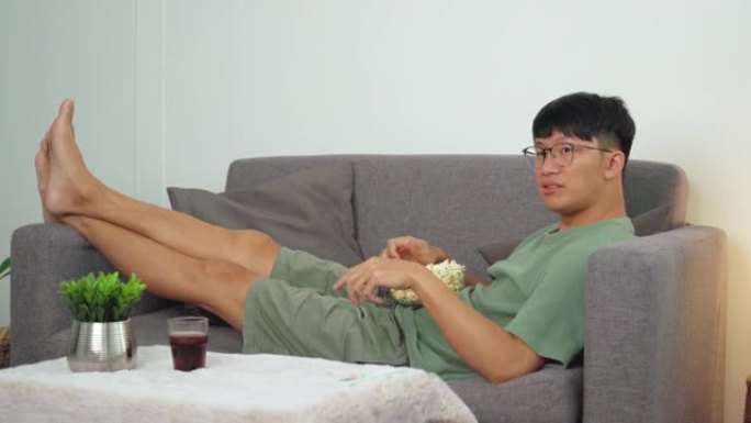 4k video footage of Asian Man is watching TV comed