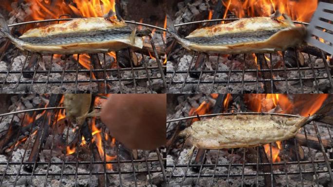 鲭鱼鱼片在烤架上用抹刀和厨房钳子旋转