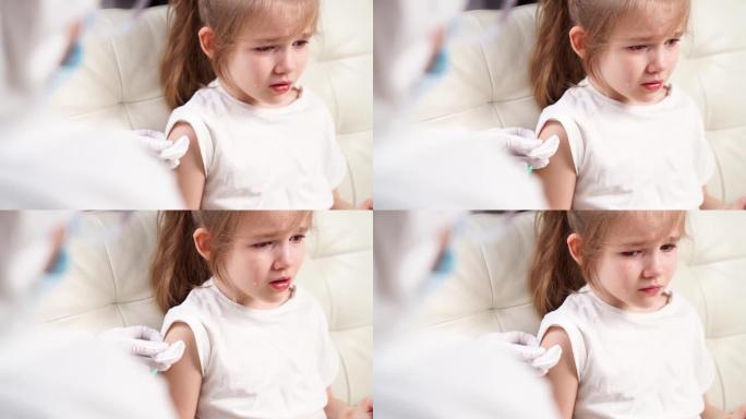 小女孩哭着受伤和害怕。医生打针。接种疫苗。