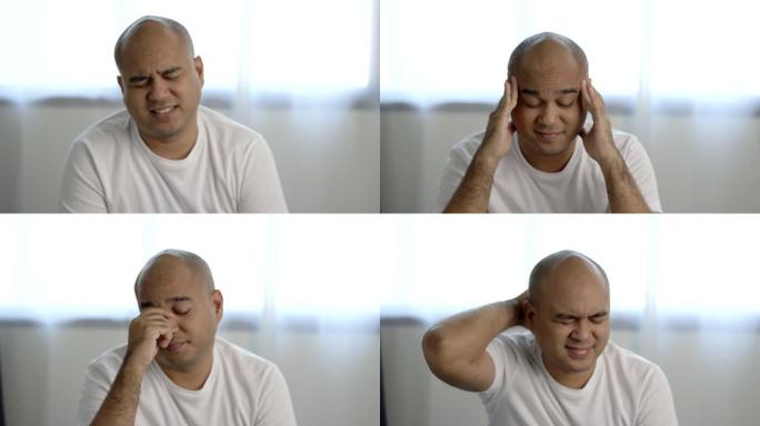 穿着白色t恤的30岁左右的亚洲秃头男人睡不好觉。他背部疼痛，颈部疼痛，无法入睡。