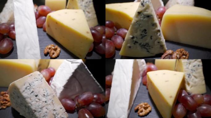 奶酪盘特写镜头，搭配几种水果和蜂蜜奶酪