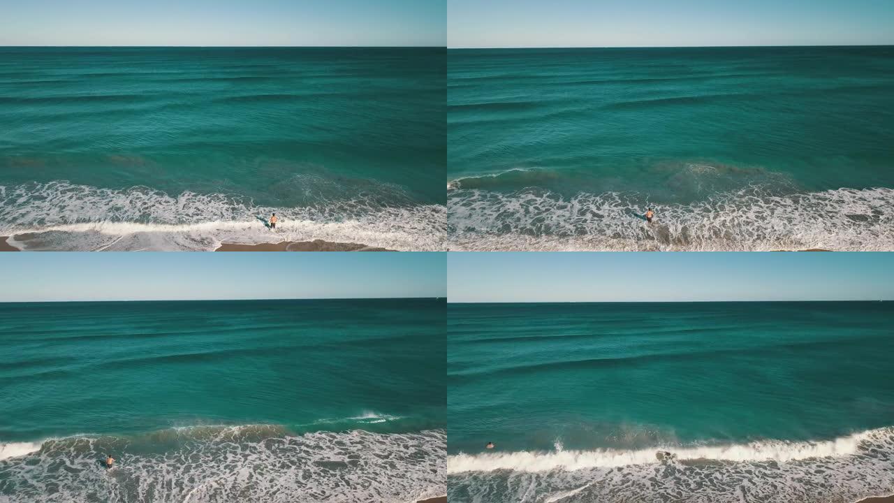 在2021年2月的一个工作日，蓝绿色的海浪席卷佛罗里达州海滨的博因顿海滩