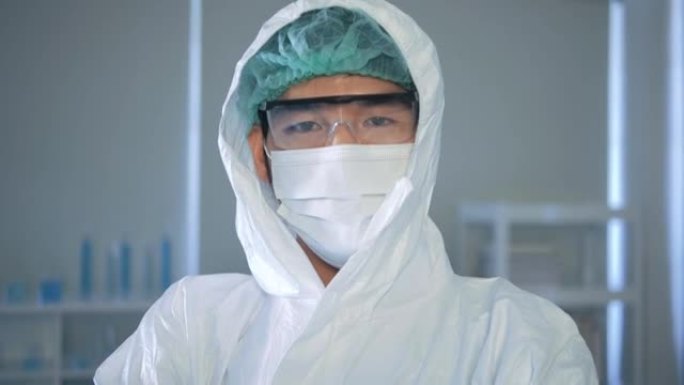 在病毒学实验室，护目镜和呼吸器中穿着防护服的亚洲肖像病毒学医务工作者
