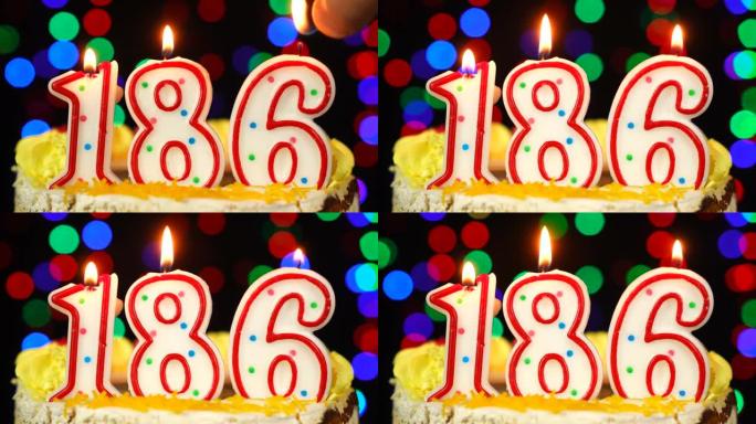 186号生日快乐蛋糕与燃烧的蜡烛顶。