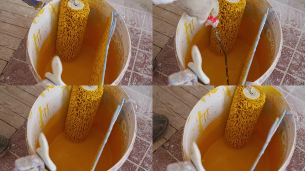 锡和油漆滚筒中的黄色墙漆