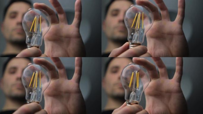 一名男电工用led灯将手中的背景模糊。重点是选择性4k