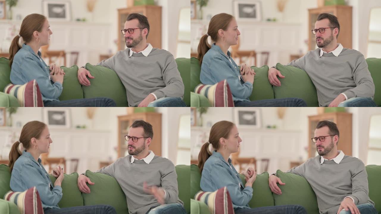 Happy Couple having Conversation while Sitting on 