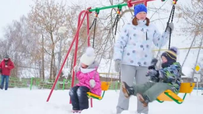 秋千上的孩子。蹒跚学步的男孩从秋千跳到深雪中