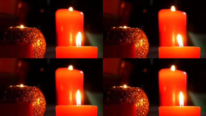 不同的装饰蜡烛在黑暗中燃烧，火焰摇摆不定。