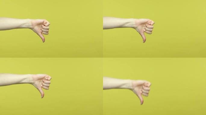 特写女性的手显示拇指向下不喜欢的手势，不赞成