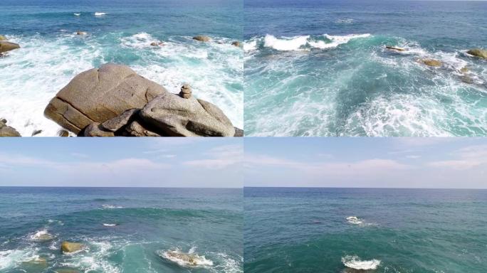 大浪在蓝色海洋中的岩石上断裂的鸟瞰图美丽的热带海洋上有海浪无人机摄像机4k拍摄鸟瞰海浪从上方撞击空石