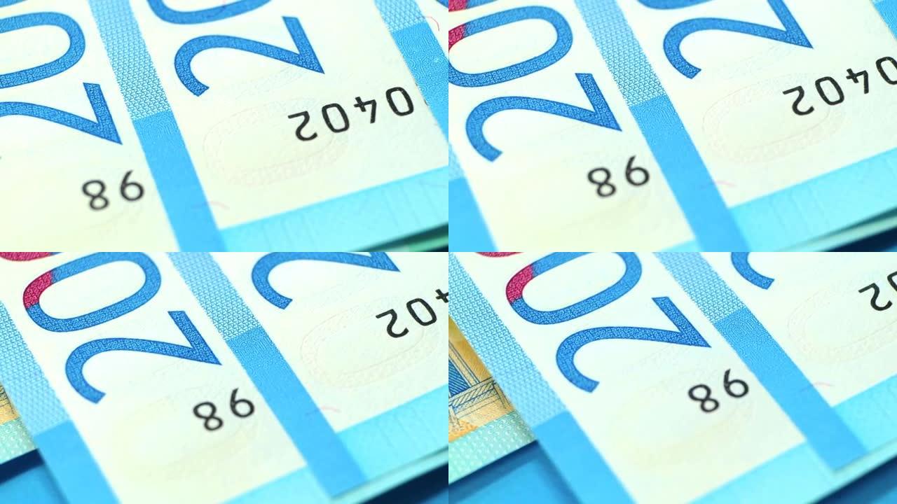 钞票特写。防止伪造。蓝色纸币。平滑旋转和浅景深。编号。