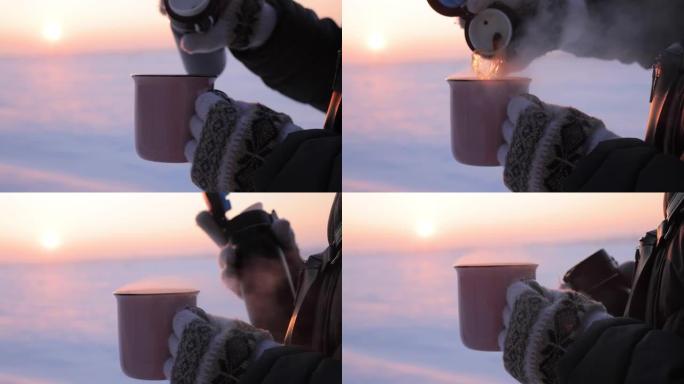 下雪天将茶从热水瓶倒入杯子中